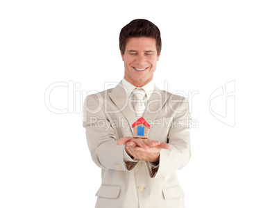 Businessman holding a house