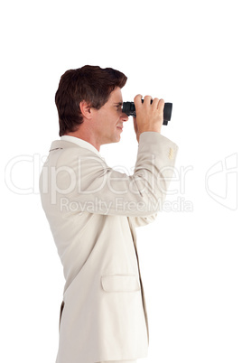 Businessman looking through a binoculars