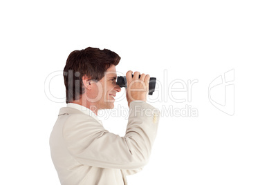Businessman looking sideways through a binoculars
