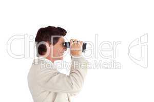 Businessman looking sideways through a binoculars