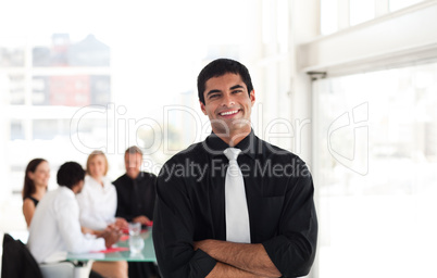 Handsome businessman standing in front of team