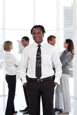 Potrait of a Businessman standing in front of team