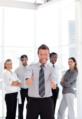 Portrait of a happy young businessman with thuumbs-up