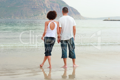 young Couple holding hands on the beach