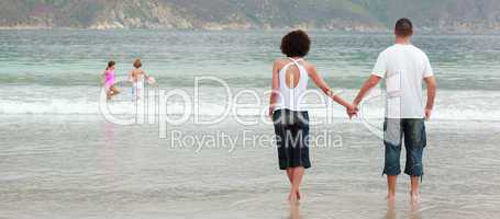 young Couple holding hands on the beach