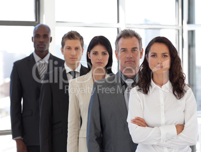 Business woman looking at camera with group in background