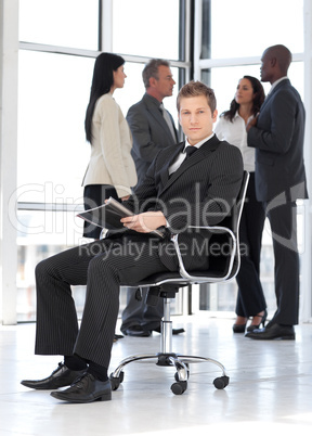 Young attractive businessman in office working