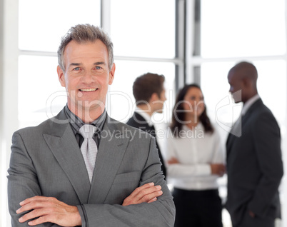 Senior Businessman with team in Background