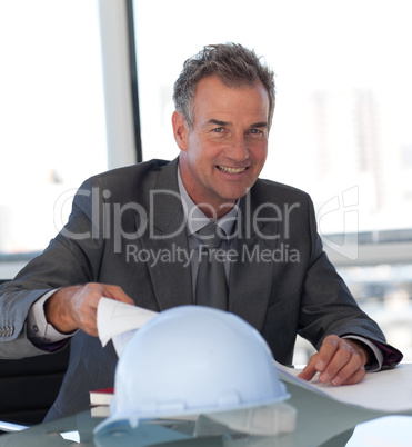 Mature Business man looking at Blueprints
