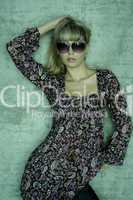 young blonde with sunglasses is posing