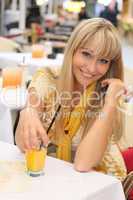 beautiful young blonde with a glass of juice