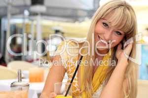 beautiful young blond woman with a glass of juice