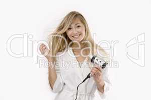 young blonde woman with hairdryer