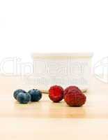 Raspberries and blueberries on table