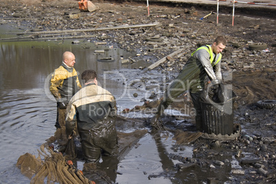 Workmen clearing the lake of fish before it gets dredged