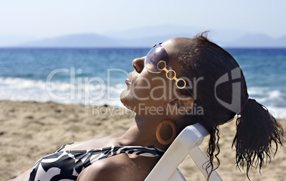 Young black woman sunbathing