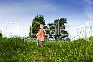 Baby girl running through the park