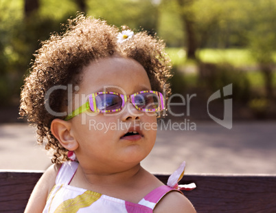 Young black baby girl with glasses
