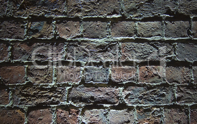 Very old (1854) brick wall with light shining from below