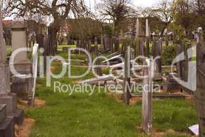 Rows of broken tombstones in a graveyard