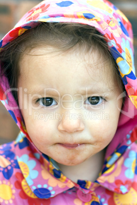 Young baby girl with a dirty face after eating chocolate