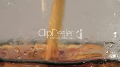 Pouring a cold glass of coke close-up