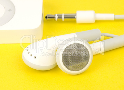 Earbuds on yellow with player