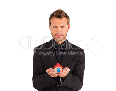Young businessman presenting a sample of house