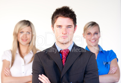 Confident businessman with businesswomen in the background