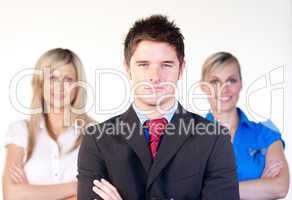 Confident businessman with businesswomen in the background