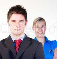 Serious businessman with businesswoman in the background