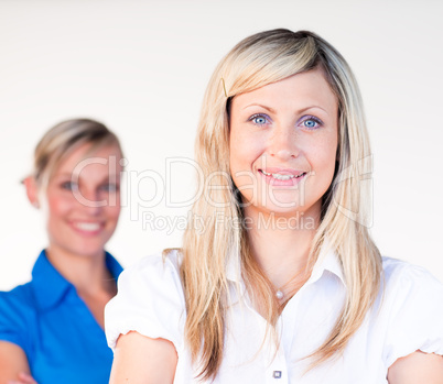 Businesswoman smiling at the camera with her colleague