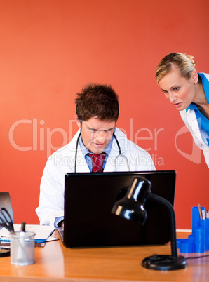 Young doctors working with a laptop in office