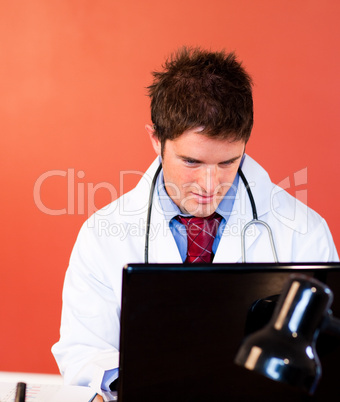 Handsome doctor working in his office