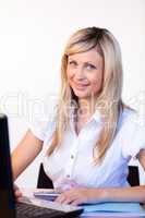 Businesswoman in office using a laptop