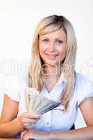 Smiling businesswoman holding dollars