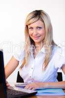 Businesswoman in office using a laptop