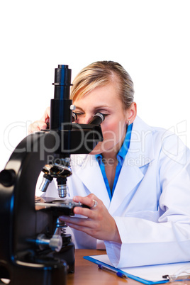 Attractive scientist viewing through microscope