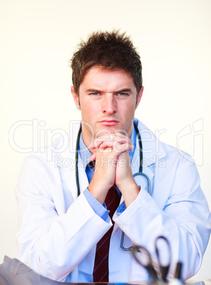 Serious young doctor looking at the camera