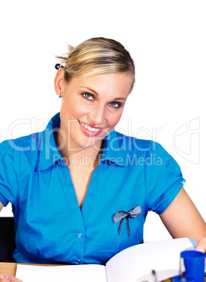 Blonde businesswoman reading and smiling at the camera