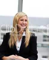 Smiling blonde businesswoman talking to a colleague