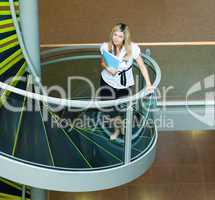 Businesswoman walking up stairs in office