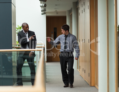 Businessmen saying goodbye in a corridor