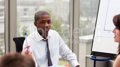 Afro-American businessman interacting with his colleagues