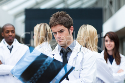 Serious doctor looking at an x-ray