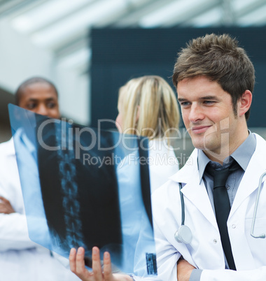 Young doctor looking at an x-ray