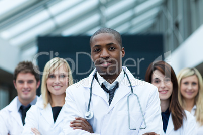 Afro-American doctor leading his team with folded arms