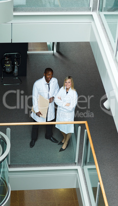 High view of male and female doctors smiling at the camera