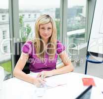Confident beautiful businesswoman working in office