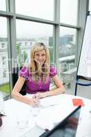 Smiling blonde businesswoman working in office